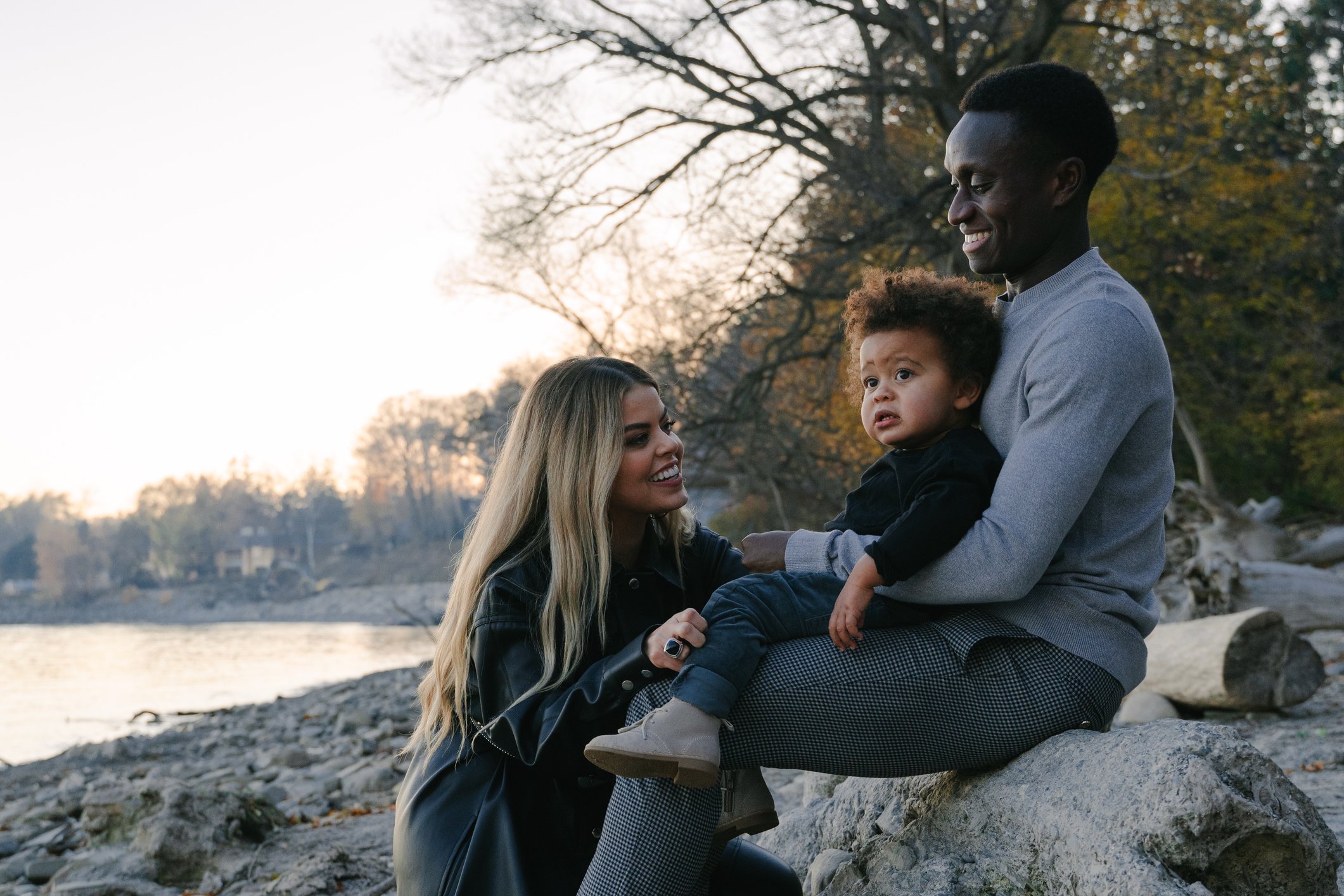 Mixed race family enjoy time together by the water Mixed race family enjoy time together by the water
