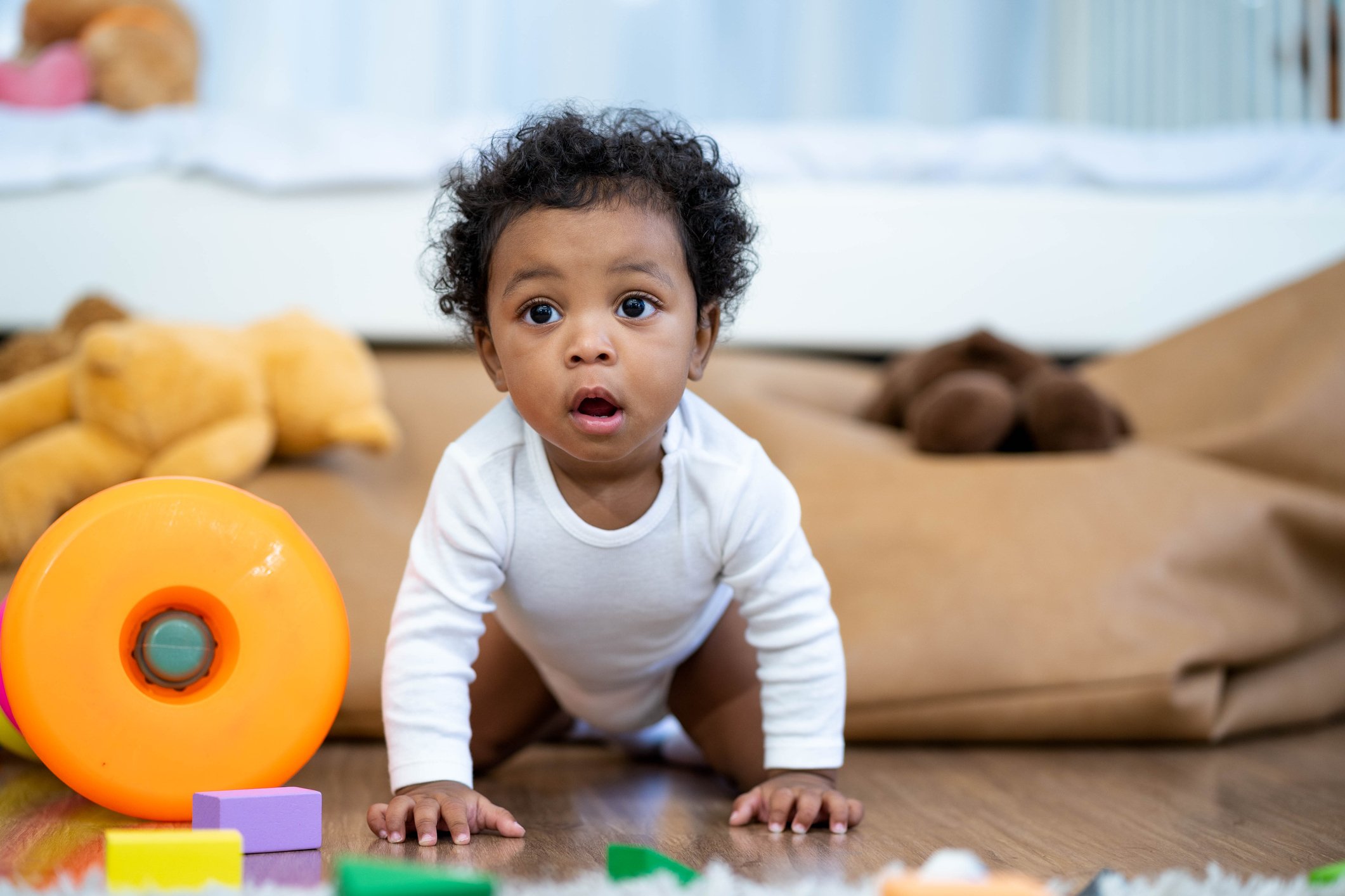 Happy African American Little baby boy crawling and looking for some thing to learn Happy African American Little baby boy crawling and looking for some thing to learn